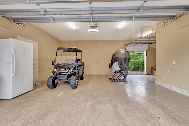 garage with white refrigerator and a garage door opener