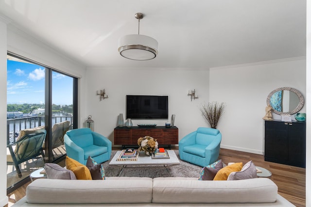 living room featuring a water view, crown molding, and hardwood / wood-style floors