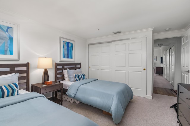 bedroom with light colored carpet, ornamental molding, and a closet