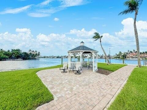 view of patio with a gazebo and a water view