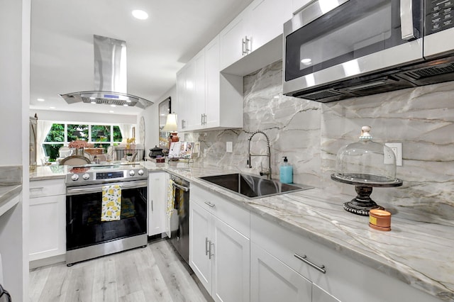 kitchen featuring white cabinets, stainless steel appliances, sink, and island range hood