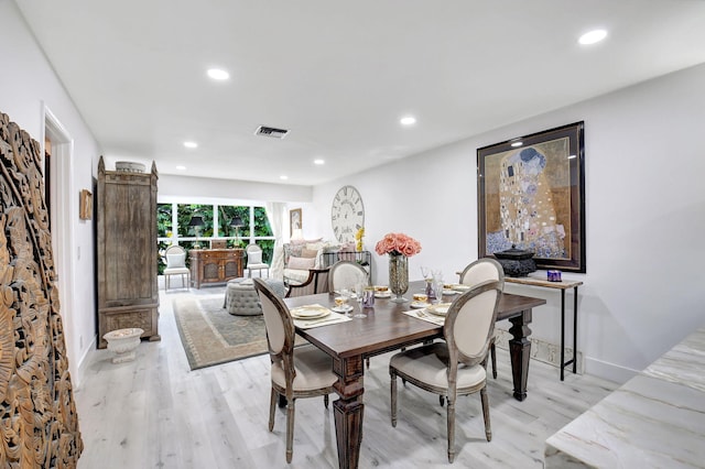 dining space featuring light wood-type flooring