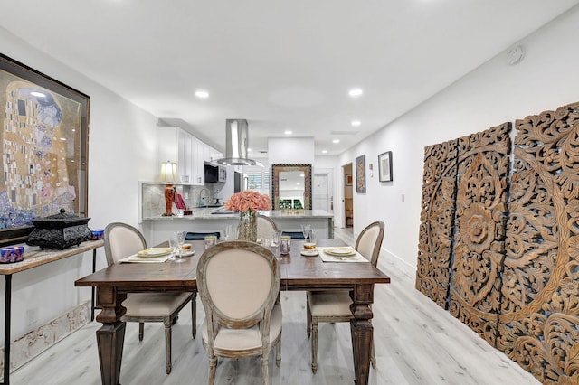 dining room featuring sink and light wood-type flooring