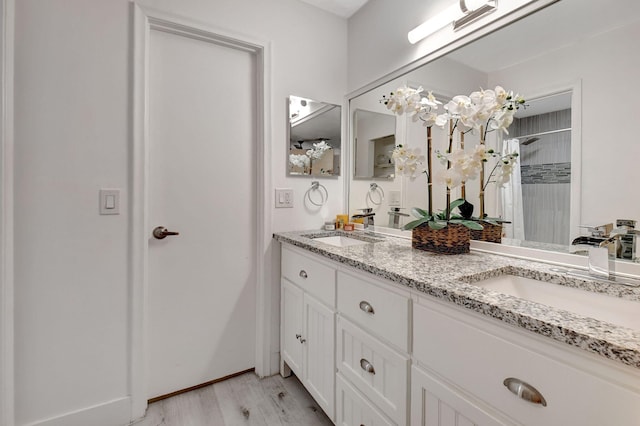 bathroom featuring vanity, hardwood / wood-style floors, and a shower with curtain