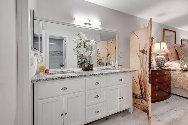 bathroom featuring vanity, wood-type flooring, and walk in shower