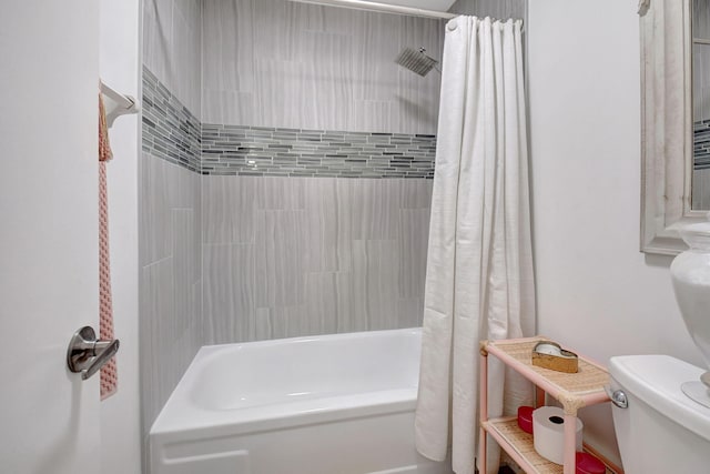 bathroom featuring shower / tub combo and toilet