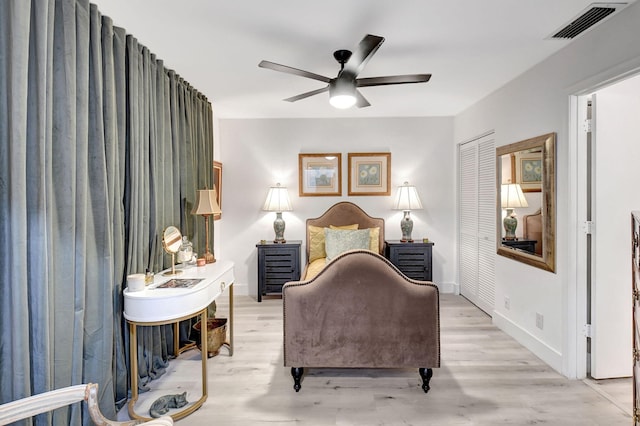 bedroom featuring a closet, ceiling fan, and light hardwood / wood-style flooring