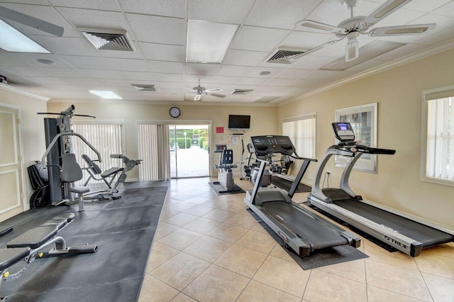 exercise room featuring crown molding, a paneled ceiling, ceiling fan, and light tile patterned floors