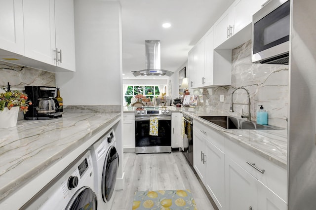 kitchen with white cabinets, stainless steel appliances, sink, and island range hood