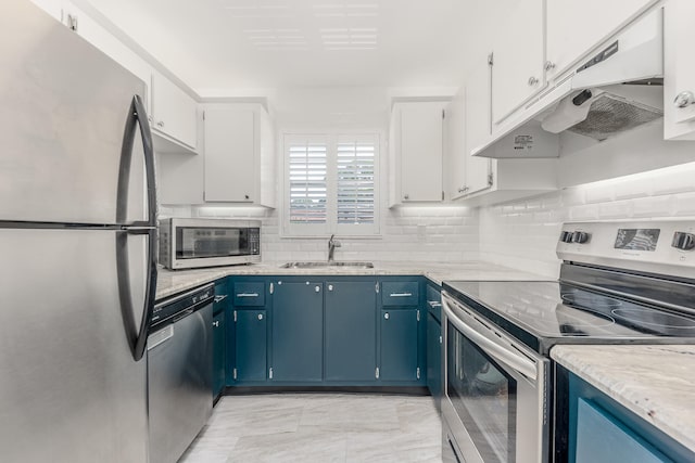 kitchen with white cabinetry, light tile patterned floors, appliances with stainless steel finishes, blue cabinetry, and sink