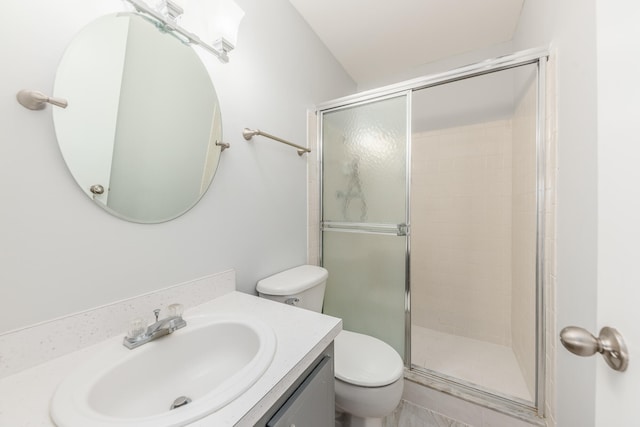 bathroom featuring tile patterned floors, vanity, an enclosed shower, and toilet