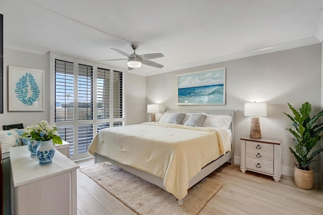 bedroom featuring access to outside, light wood-type flooring, and ceiling fan