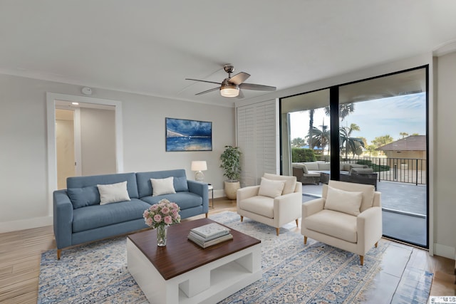 living room featuring crown molding, ceiling fan, and light hardwood / wood-style floors