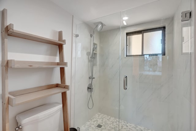 bathroom with an enclosed shower and toilet