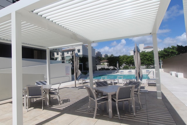 view of patio with a pergola and a community pool