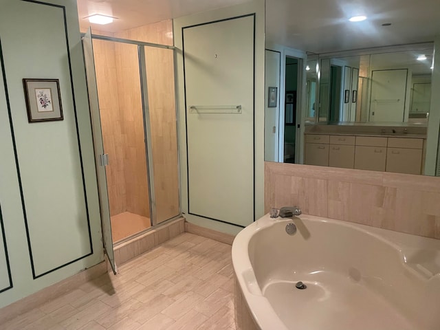 bathroom with vanity and independent shower and bath