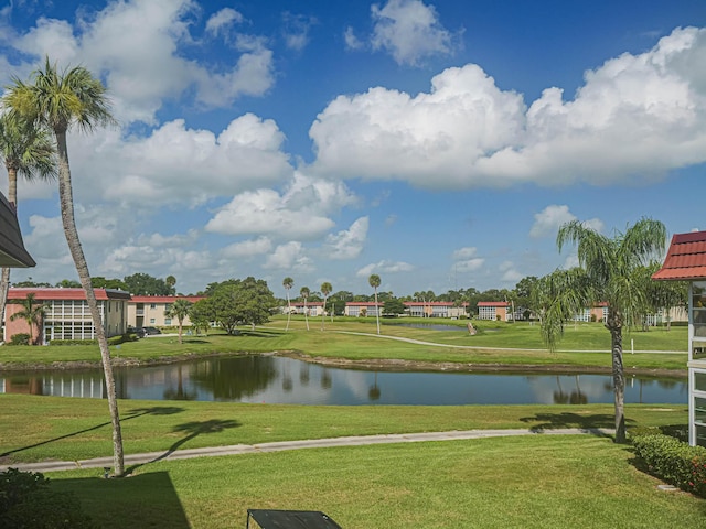 surrounding community featuring a water view and a yard