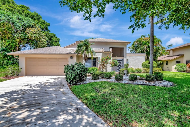 view of front facade with a garage and a front lawn