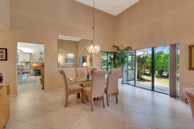 tiled dining space with a high ceiling and a notable chandelier