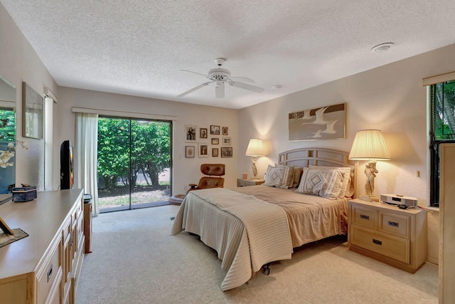 carpeted bedroom featuring ceiling fan, a textured ceiling, and access to outside