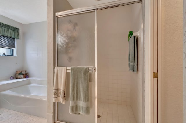 bathroom featuring independent shower and bath