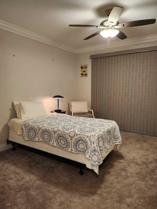 carpeted bedroom featuring ceiling fan and ornamental molding