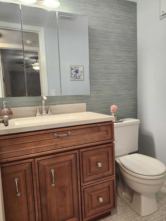 bathroom with tile patterned flooring, vanity, and toilet