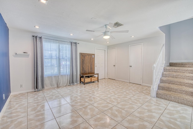 unfurnished room featuring light tile patterned floors and ceiling fan