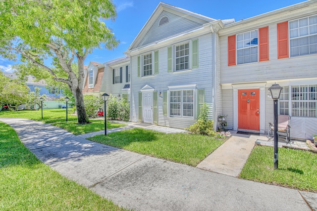 view of property featuring a front lawn