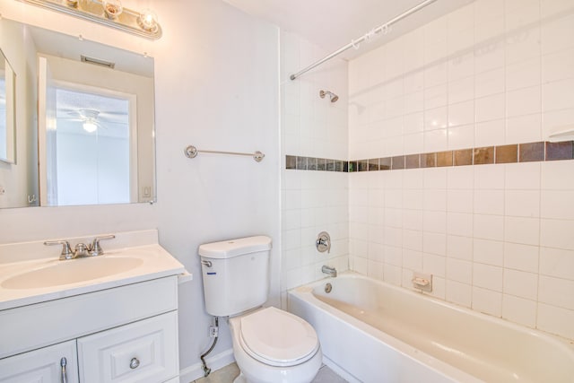 full bathroom with vanity, toilet, tiled shower / bath, and ceiling fan