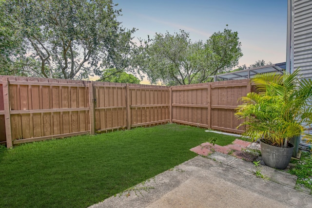 yard at dusk featuring a patio