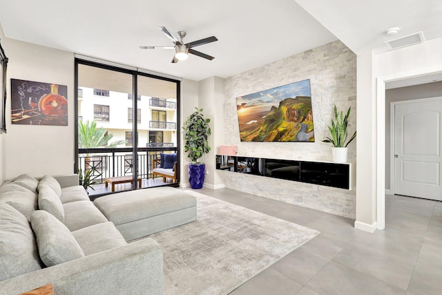 living room featuring light tile patterned floors, ceiling fan, and floor to ceiling windows