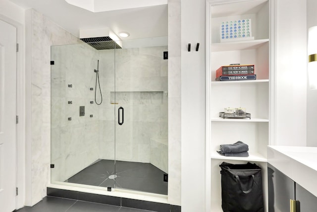 bathroom with built in features and walk in shower