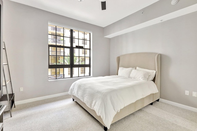 bedroom featuring ceiling fan and light colored carpet