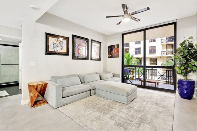 living room featuring tile patterned flooring, expansive windows, and ceiling fan