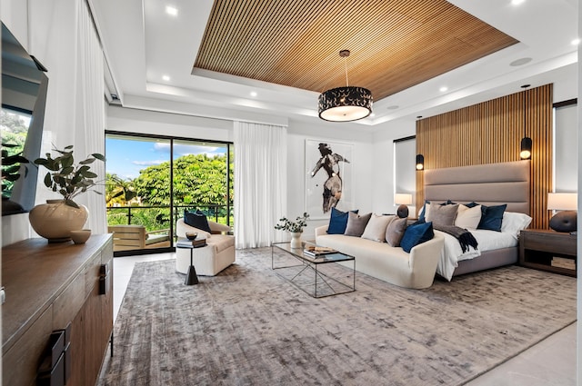 bedroom with a tray ceiling and multiple windows