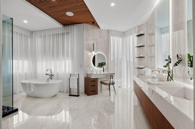 bathroom featuring vanity and a tub to relax in