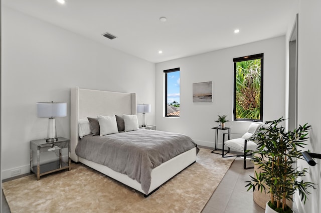 tiled bedroom featuring multiple windows