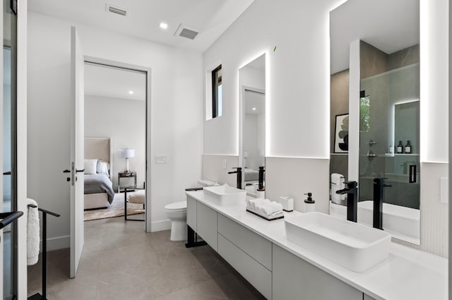 bathroom with vanity, toilet, and an enclosed shower