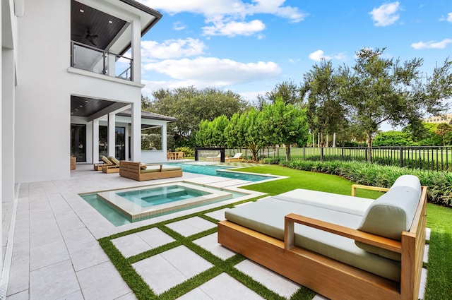 view of swimming pool featuring an in ground hot tub and a patio area