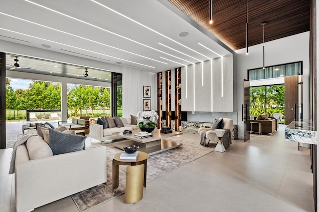 living room featuring ceiling fan and plenty of natural light