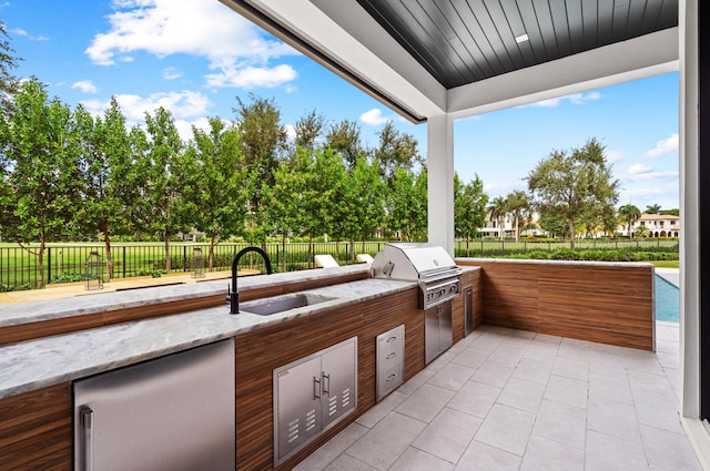 view of patio featuring area for grilling, grilling area, and sink