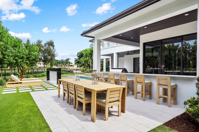 view of patio with a playground and a bar