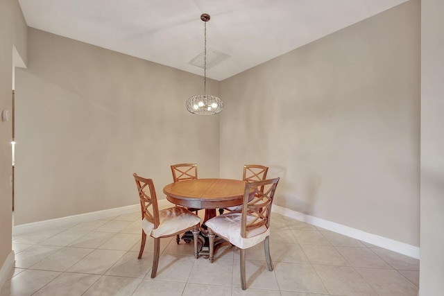 dining space featuring light tile patterned flooring and a notable chandelier