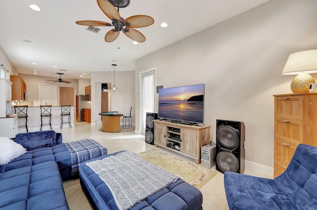 living room featuring light tile patterned floors and ceiling fan