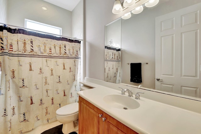 bathroom featuring vanity, tile patterned floors, and toilet