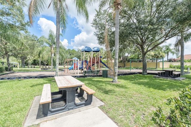 view of home's community featuring a yard and a playground