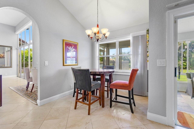 dining area featuring vaulted ceiling, a chandelier, and plenty of natural light