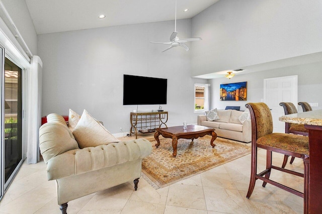 living room with high vaulted ceiling and ceiling fan