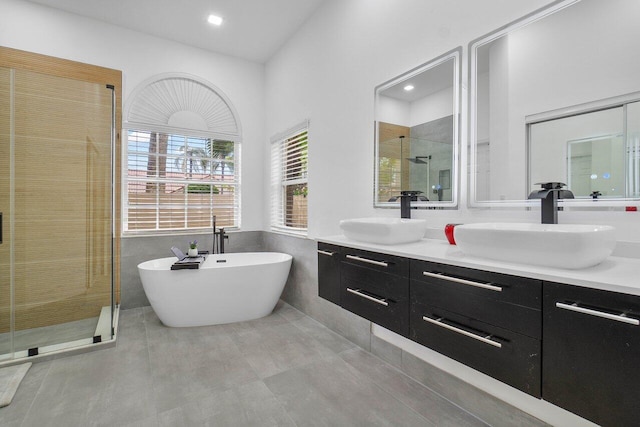 bathroom featuring vanity and separate shower and tub